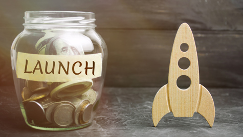 Glass Jar With The Word Launch And Rocket. The Concept Of Raising Funds For A Startup. Charitable Contributions To Translate Ideas Or Project. Investing In The Future. Launch A Business Idea